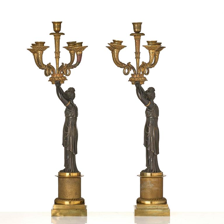 A pair of Fernch Empire ormolu and patinated bronze five-light candelabra, early 19th century.