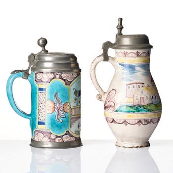 Two German faiance tankards with tin mountings, 18th century.