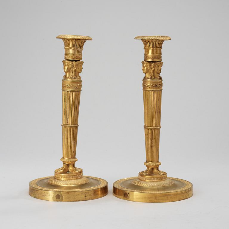 A pair of French Empire early 19th century candlesticks.