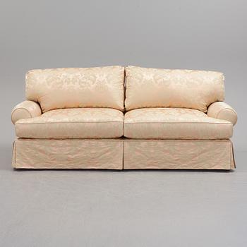 A sofa upholstered with silk damask.