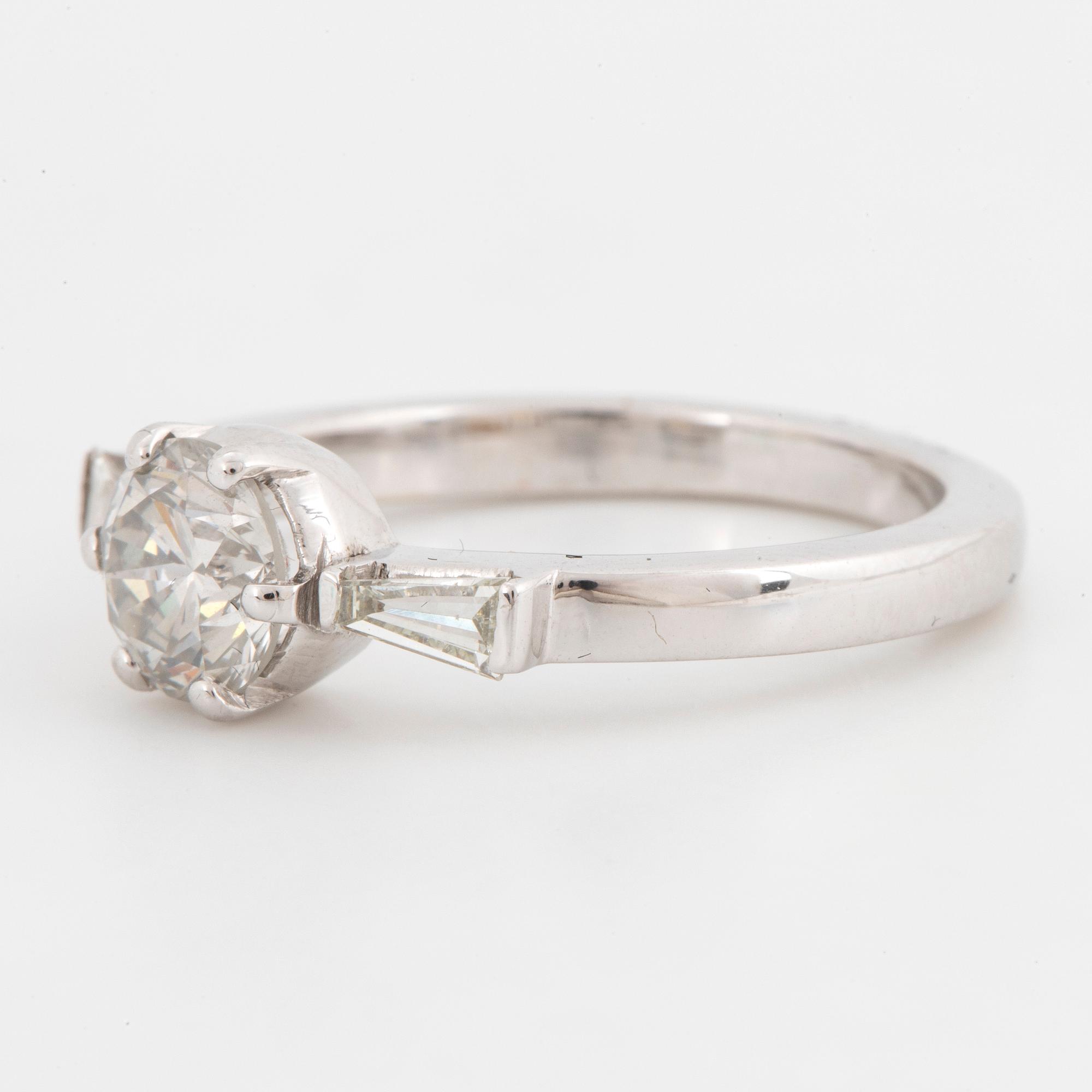 A 14K gold ring set with a round brilliant-cut diamond.