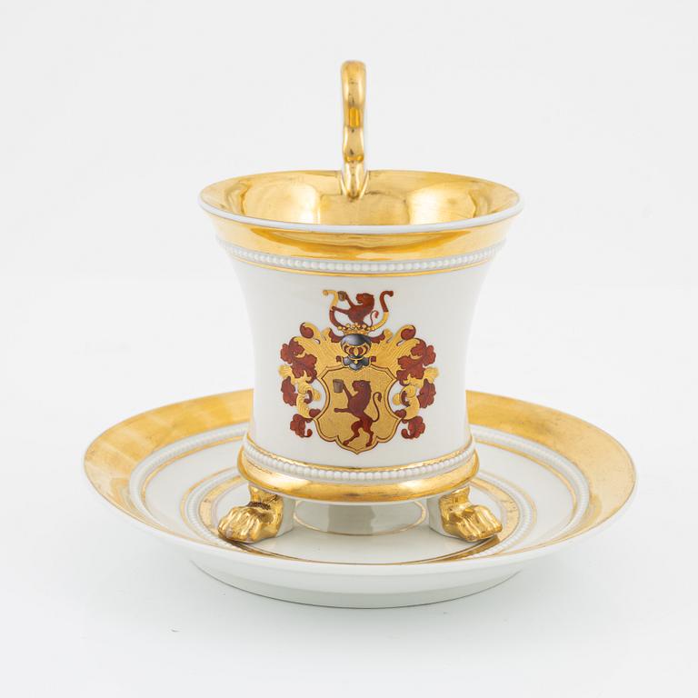 An Empire style porcelain cup and saucer, Germany, circa 1900.