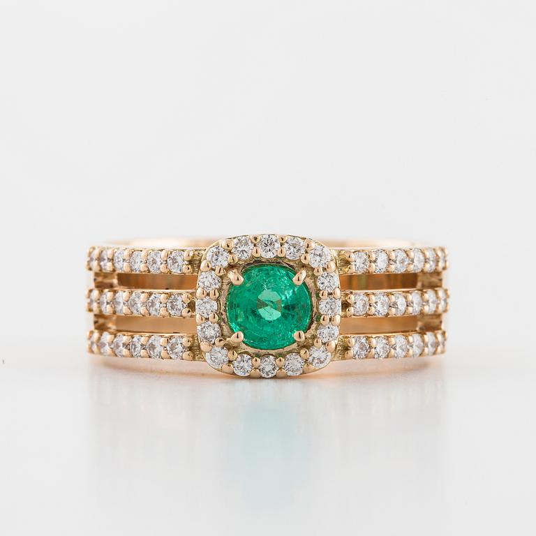 A faceted emerald and brilliant cut diamond ring.