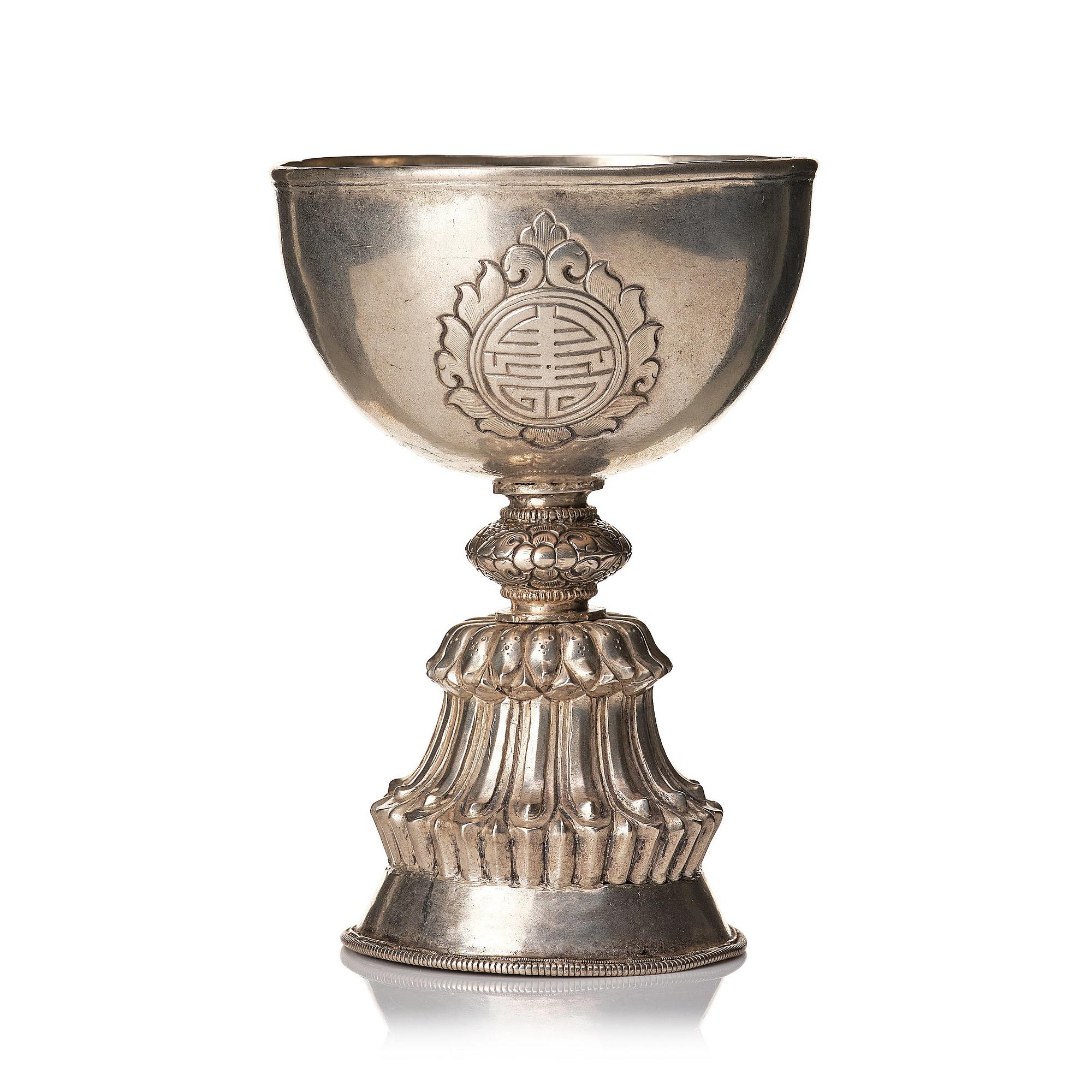 A Tibetan butter lamp, silvered copper, 20th century.