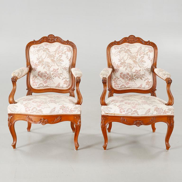 A pair of rococo style arm chairs, early 20th century.