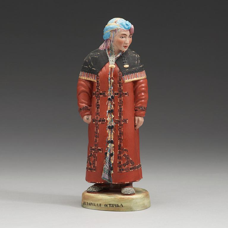 A Russian bisquit figure depicting a Khanty woman, Kusnetsov, first half of 20th Century.