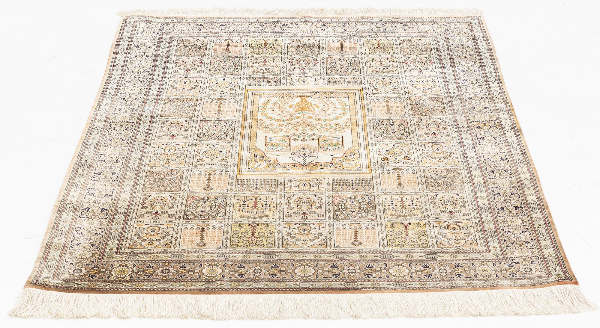 A carpet, oriental silk, circa 145 x 97 cm.