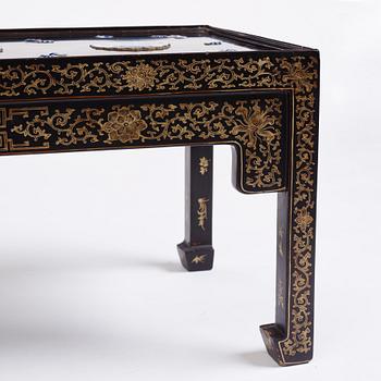A Chinese black lacquered table with porcelain placques, presumably first half of the 20th century.