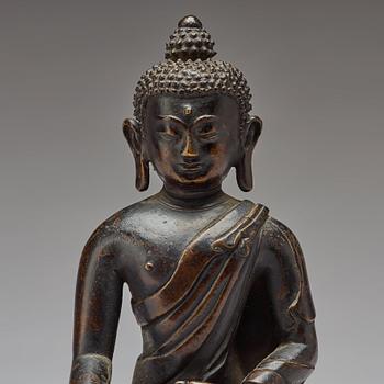 A copper alloy figure of Buddha Shakyamundi, Tibet, 17th Century.