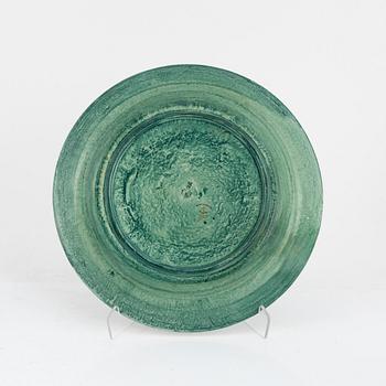 Josef Ekberg, 11 ceramic side plates and a dish, Gustavsberg, 1920's.