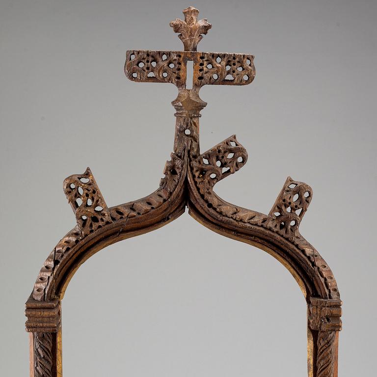 A possibly 16th century carved dark wood picture frame.