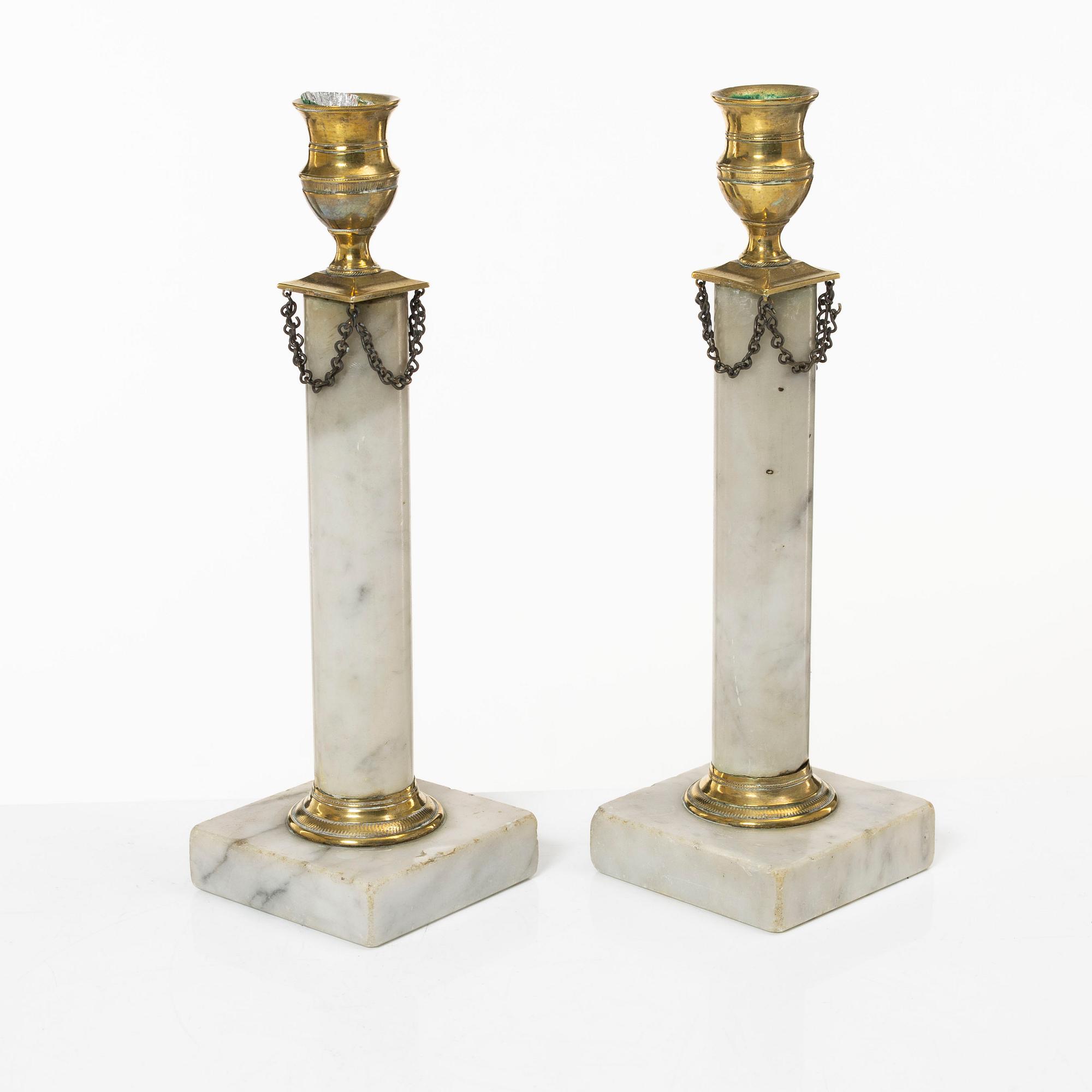 A pair of Gustavian brass and marble candlesticks, circa 1800.