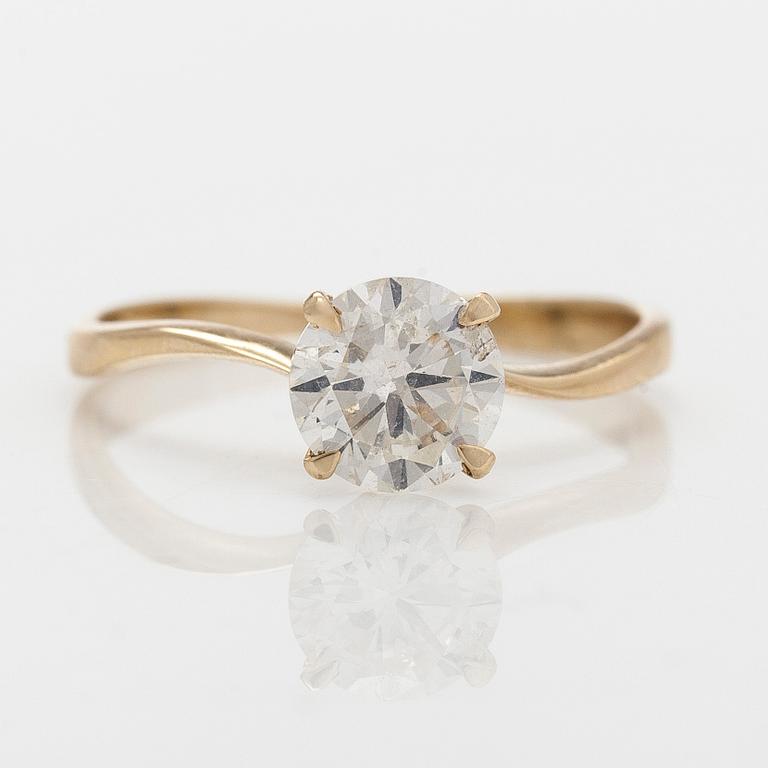 A 14K gold ring with brilliant cut diamond.