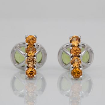 A pair of peridot and sapphire cufflinks. Peridots circa 6.10 cts and yellow sapphires circa 1.50 cts in total.