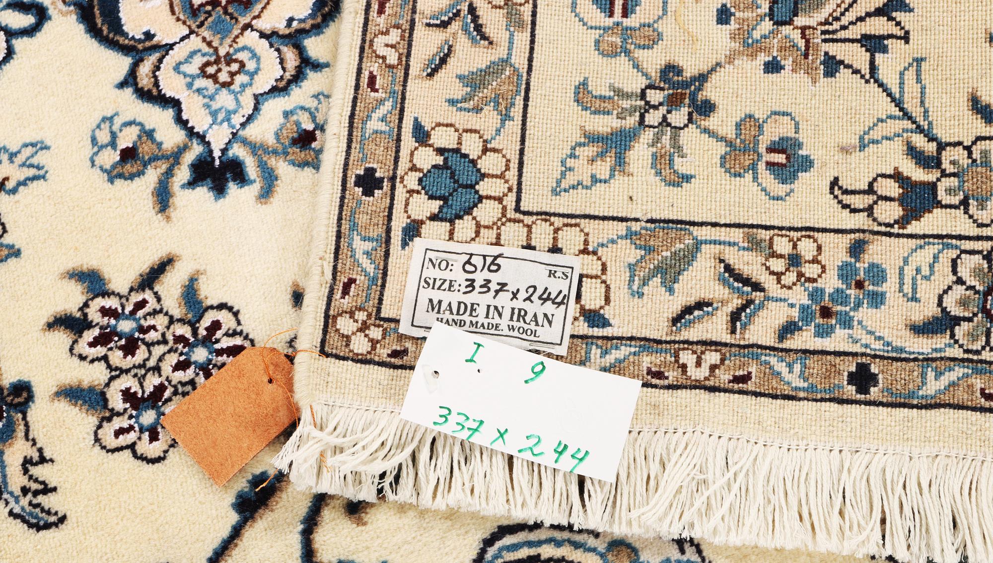 A Nain, part silk carpet, c. 337 x 244 cm.