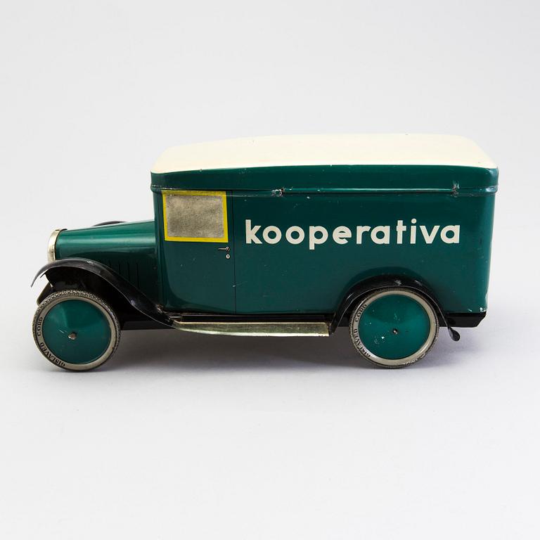 A tinplate biscuit jar in the shape of a truck 1930s.