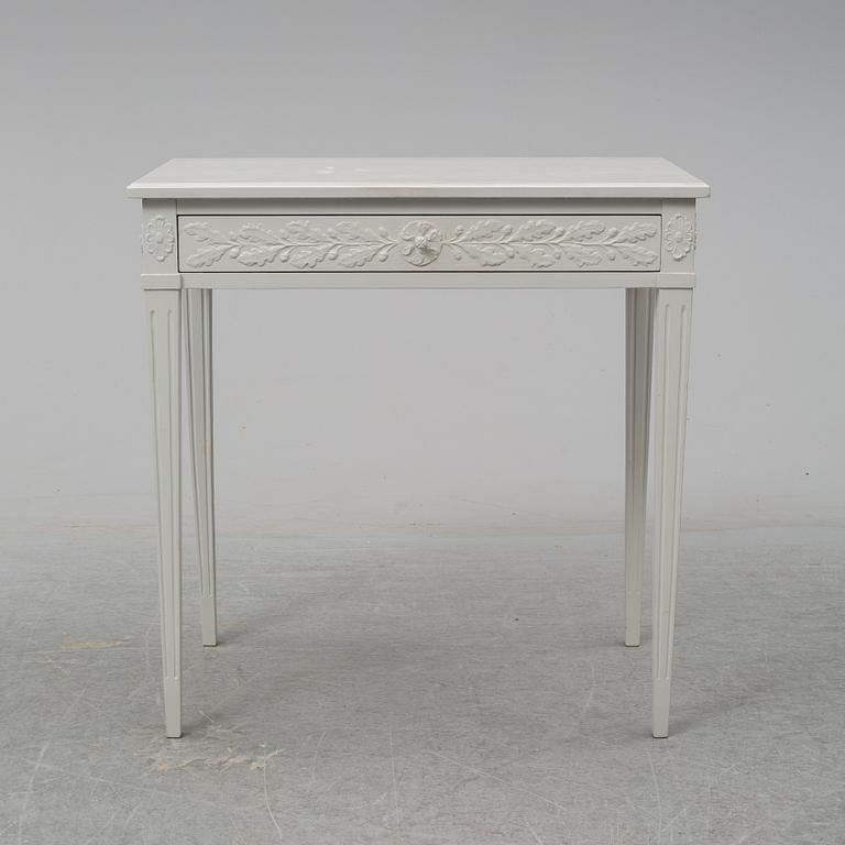 A late Gustavian style table with a drawer from around year 1900.