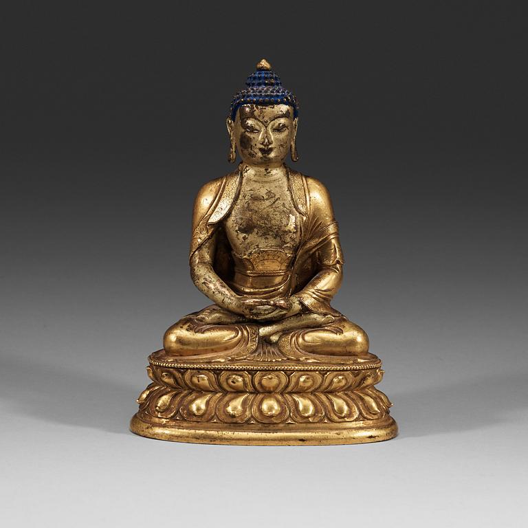 A seated Sino-Tibetan part gilt bronze figure of Amithaba Buddha, 18th Century.