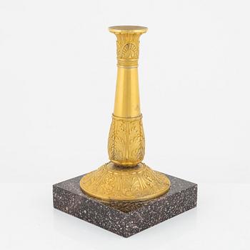 A bronze and porphyry candlestick, 20th Century.