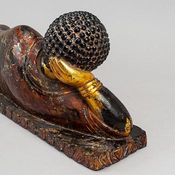 A large gilt and lacquered figure of reclining buddha, Thailand, circa 1900.