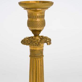 A pair of Empire ormolu brass candlesticks, France early 19th century.