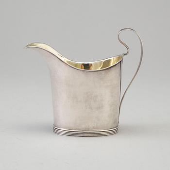 a 1824's silver creamer.