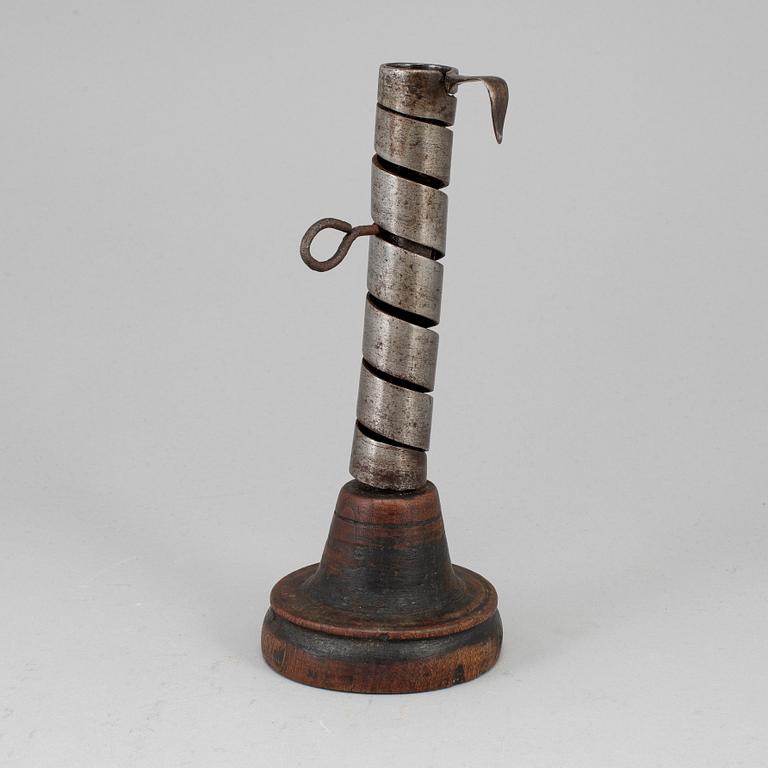 An 18th century wood and iron candlestick.