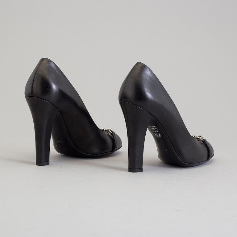 A pair of black pumps by Gucci.