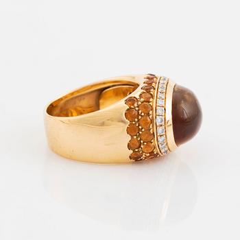 An 18K gold ring set with a cabochon-cut citrine and round brilliant-cut diamonds och citrines.
