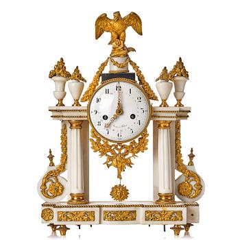 107. A Louis XVI gilt bronze and white marble mantel clock.