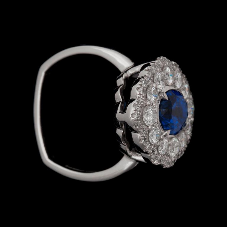 An untreated sapphire ring 2.65 cts framed by brilliant cut diamonds, total carat weight circa 1.20 ct.