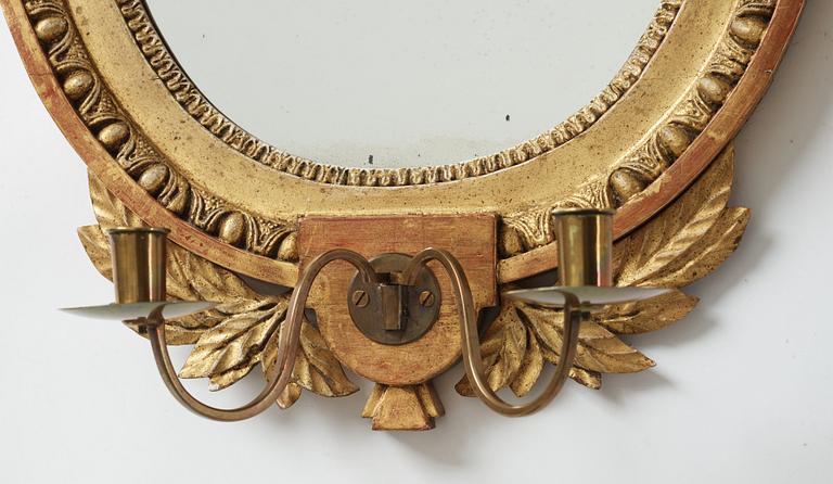 A late gustavian girandole mirror signed by Claes Eric Reding, Karlskrona, (master 1808-1815).