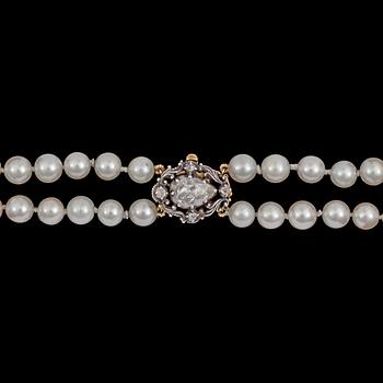 A two strand cultured pearl necklace, 7,4 mm, rose cut diamond clasp.