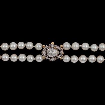 A two strand cultured pearl necklace, 7,4 mm, rose cut diamond clasp.