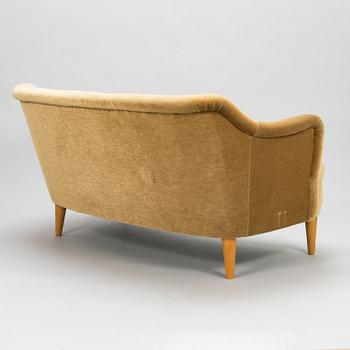 A mid-20th-century sofa and armchair.