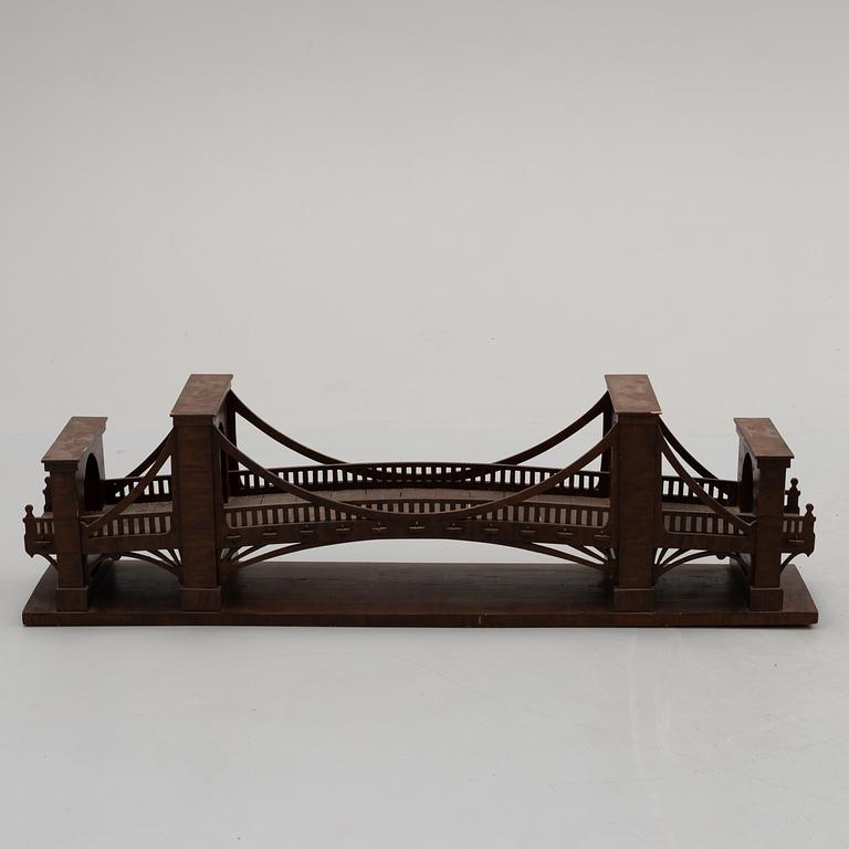 An early 20th century wood model of a bridge.