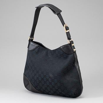 GUCCI, a black canvas and leather bag.