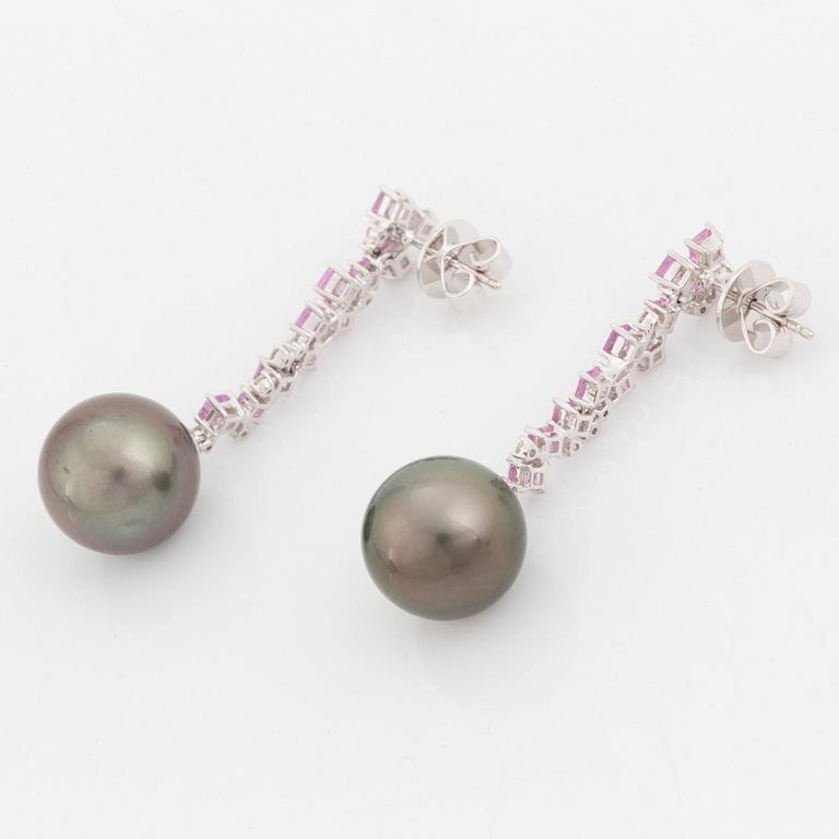 A pair of 18K white gold earrings set with Tahitian cultured pearls and round brilliant-cut diamonds.