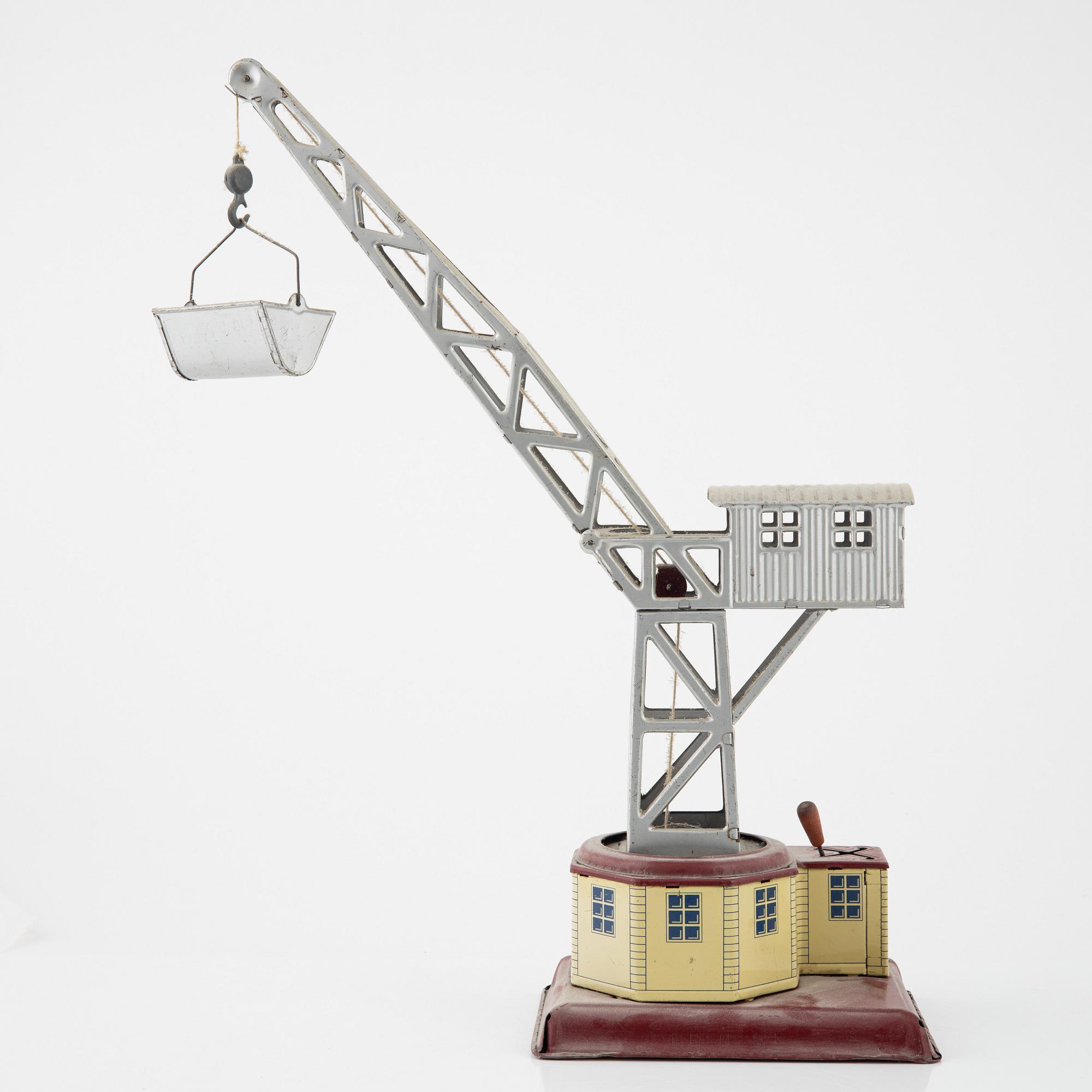 Three tin toys including a Gescha tank, Germany, mid 20th century.