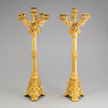 A pair of mid 19th century Empire gilt bronze candelabras.