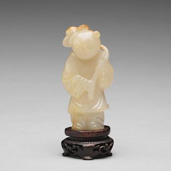 685. A carved nephrite figure of a boy with a lotus branch, Qing dynasty (1644-1912).