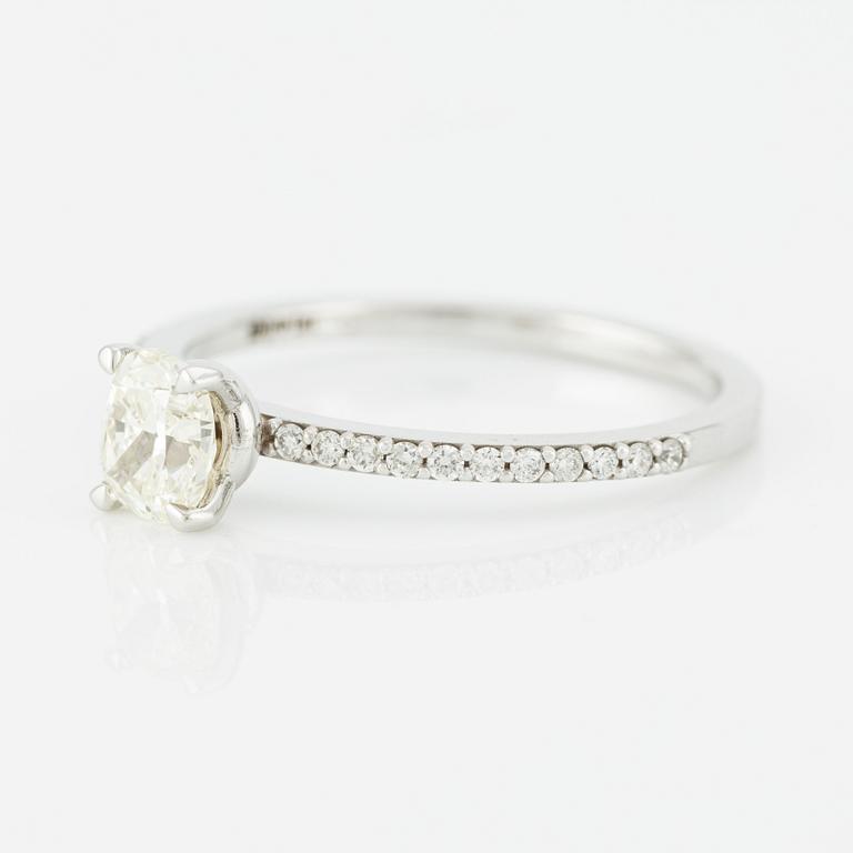 Ring with cushion-cut diamond.