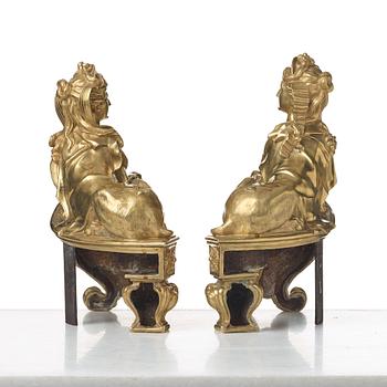 A pair of Louis XV fire dogs, France, mid 18th century, the design of the sphinxes attributed Nicolas Coustou 1658-1733.