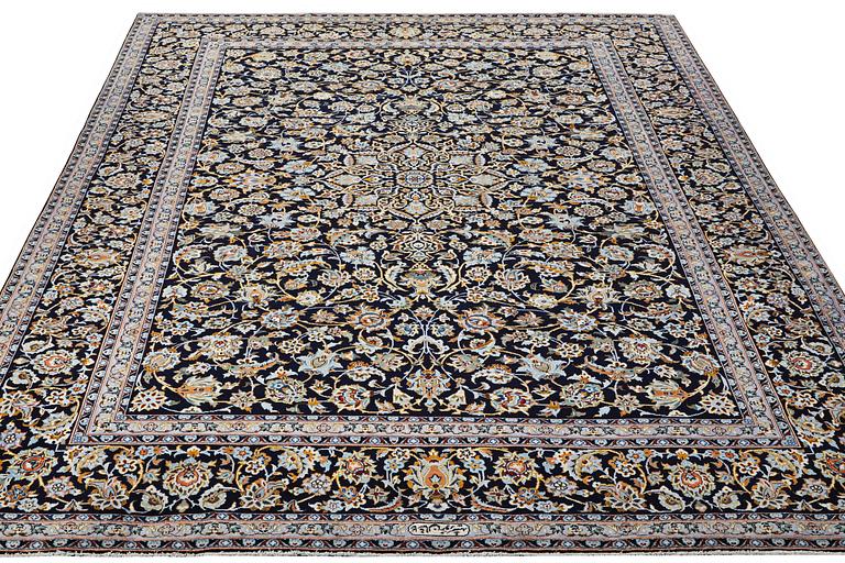 A Kashan carpet, signed, c. 381 x 285 cm.