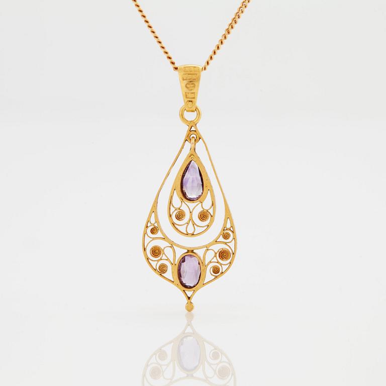 A PENDANT set with amethysts.