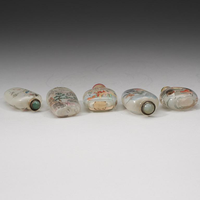 A group of five Chinese inside decorated snuff bottles with stoppers, early 20th Century.