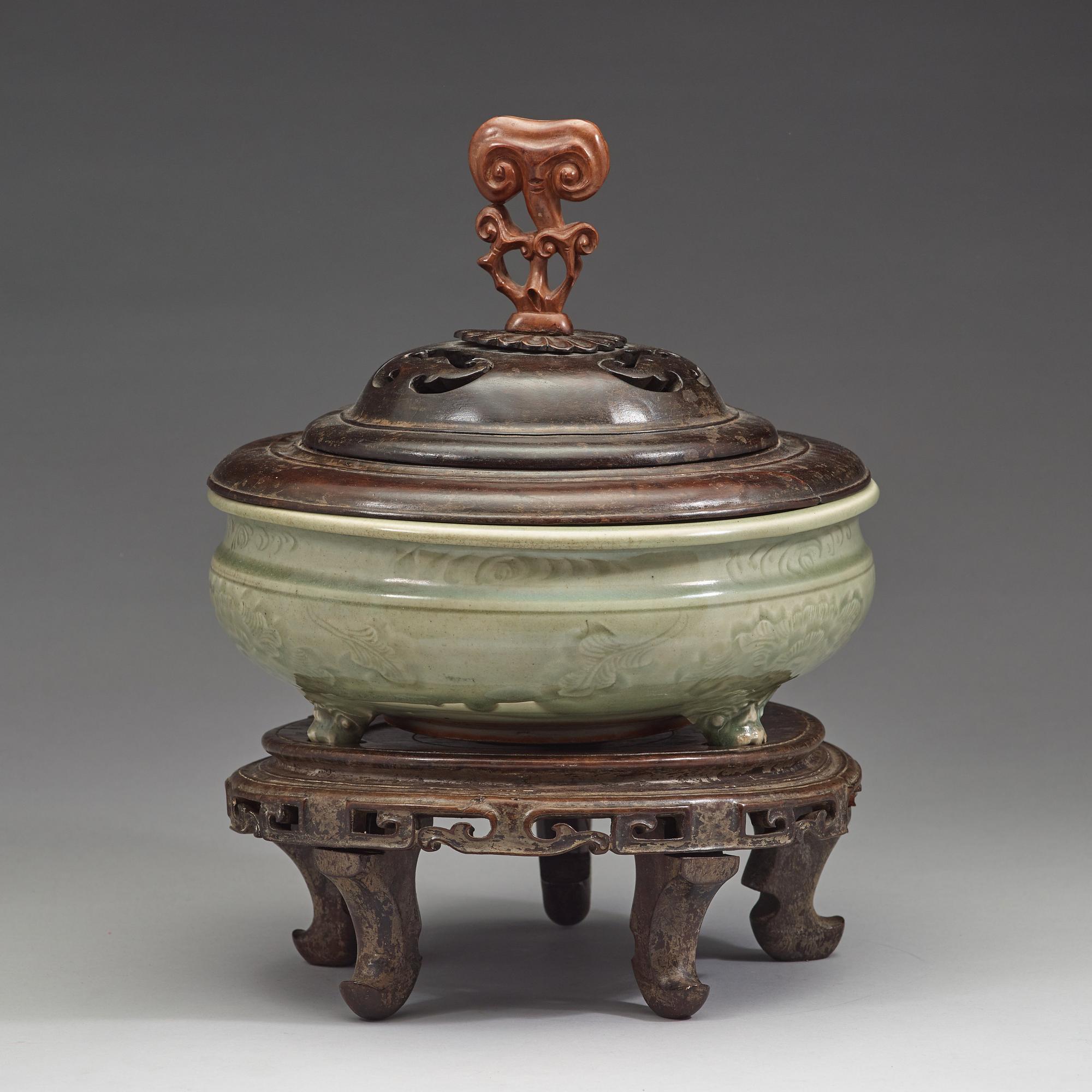 A large tripod celadon censer, presumably late Ming dynasty (1368-1644).