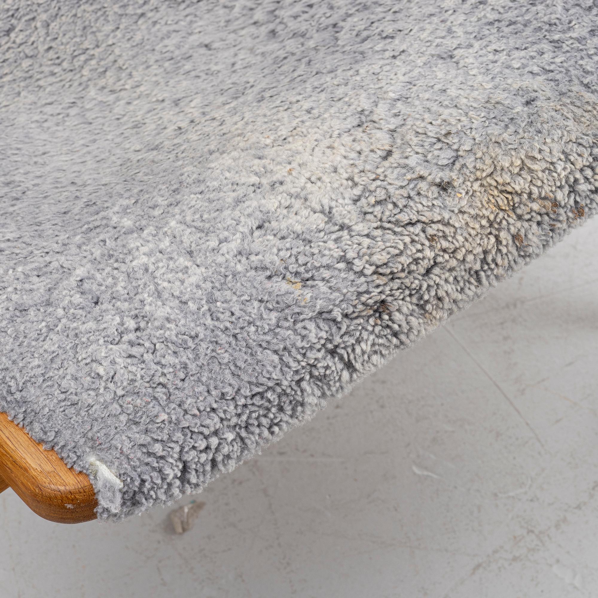 Yngve Ekström, a 'Lamino' armchair with ottoman and sidetable, Swedese, Sweden, 21st century.