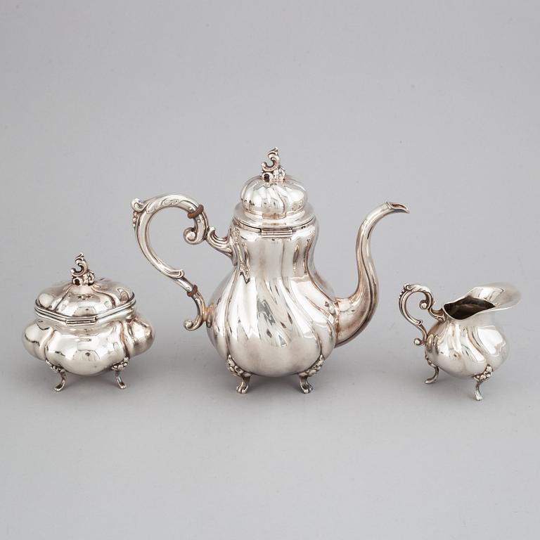 A silver coffee pot, creamer and sugar bowl. Swedish import marks.