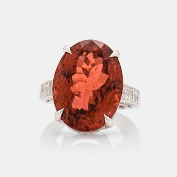 A circa 30.40 ct orange tourmaline and diamond ring. Total carat weight of diamonds circa 1.25 cts.